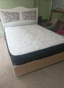 A clean double bed with a medical mattress It is located ...