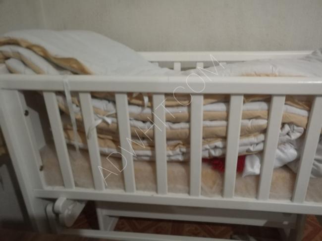 Rocking baby bed with mattress