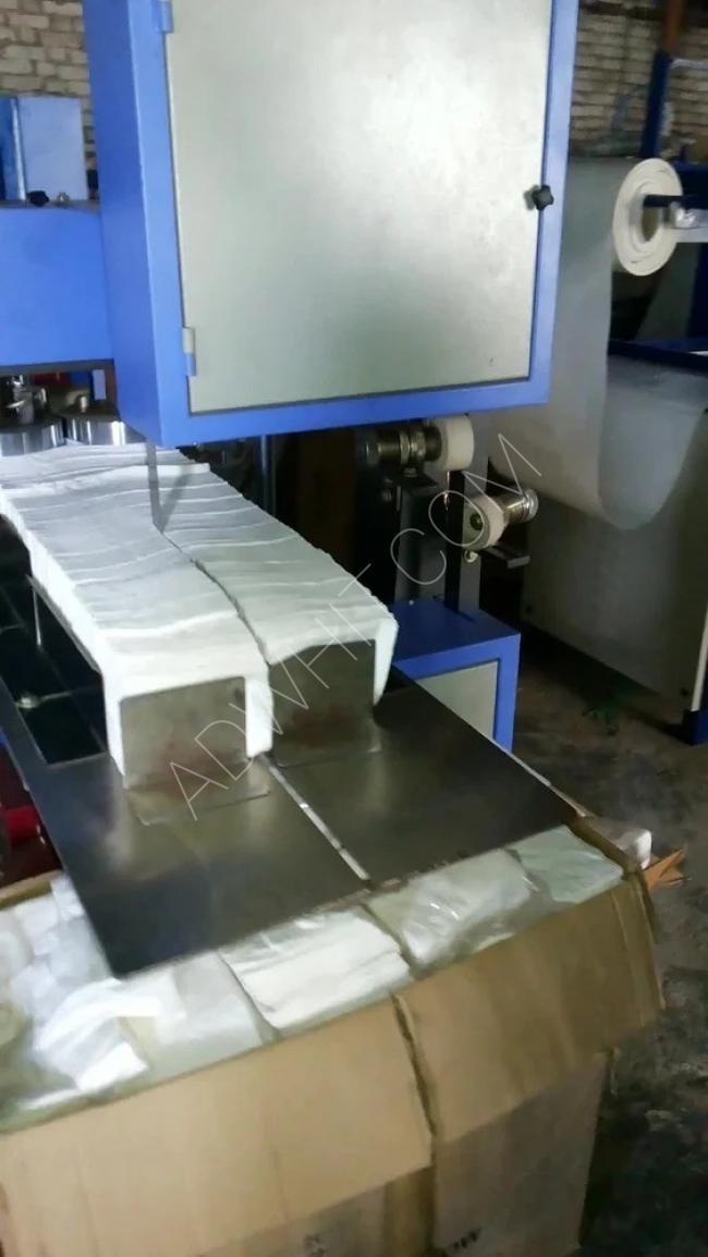 A machine that folds napkins into a square shape