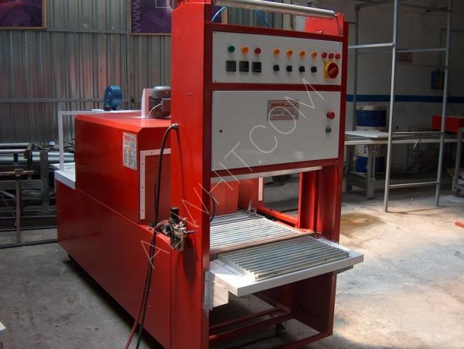 Shrink wrapping machine for wrapping bottles and chicken