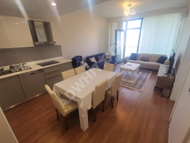 For sale, a furnished 1+1 apartment with complete and almost new furniture, within the new residential complex Göl Panorama in Bahçeşehir area