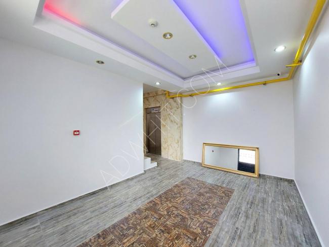 For sale, an apartment in Mersin with two rooms, a living room, and an American kitchen