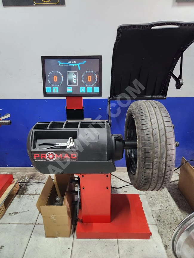 Tire balancing machine with a touch screen, equipped with laser and sonar