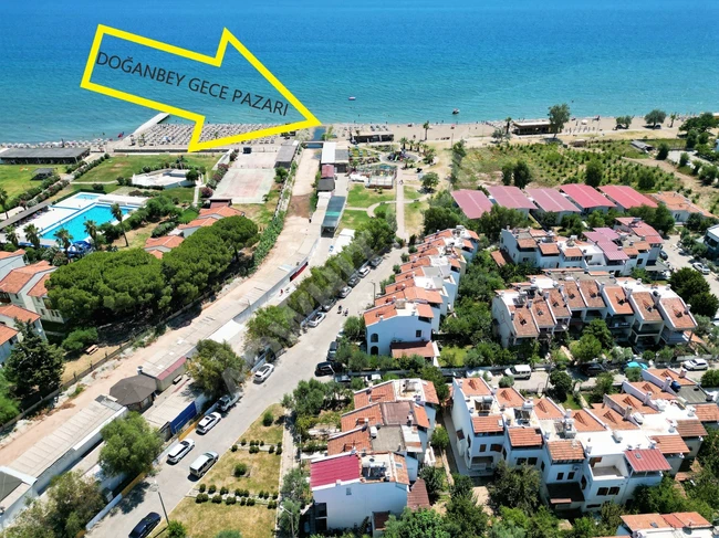 3+1 villa for sale in Doganbey within a residential complex by the sea