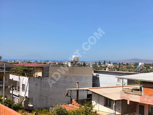 1+1 apartment for sale in Urkmez near the sea with a view