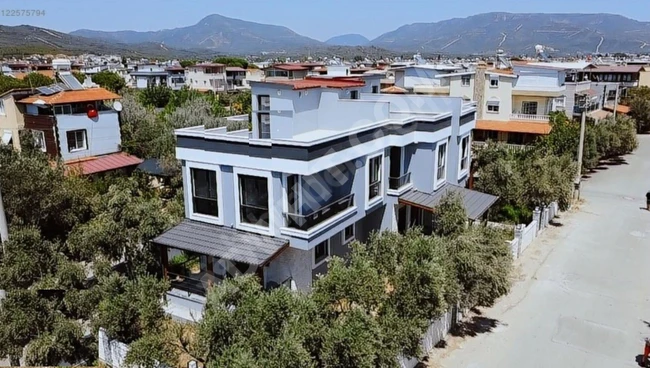 Corner 3+1 villa with a front green area near the sea in Doğanbey