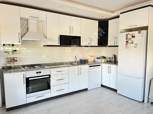 A new apartment for sale, covering an area of 85 square meters in the center of Orkmaz Seferihisar, featuring two rooms and a living room