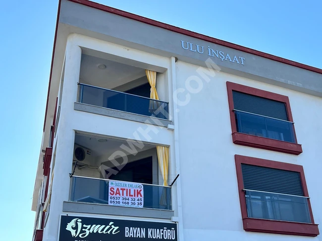 A new apartment for sale, covering an area of 85 square meters in the center of Orkmaz Seferihisar, featuring two rooms and a living room